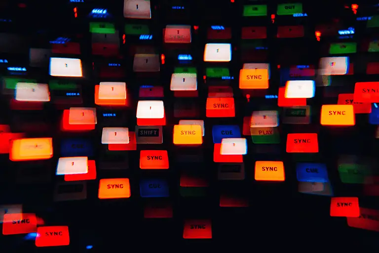 A collection of sync buttons representing UK sync licensing revenue hit £43.9 million in 2024 (BPI), an 11.3% increase year-on-year. Major brands' Christmas campaigns can triple normal music budgets