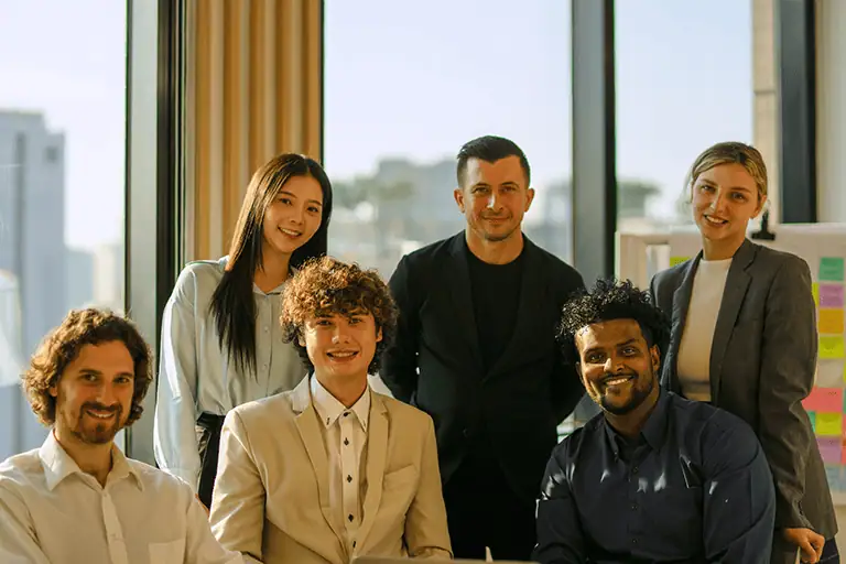 A group of interns from different backgrounds are subject to National Minimum Wage regulations since 2010 - reflecting legal compliance and reduced access for working-class candidates