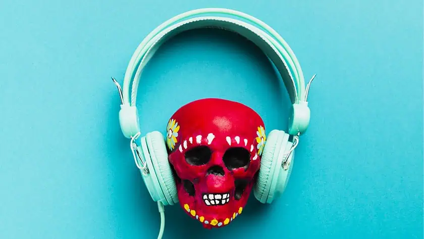 A painted skull and headphones exemplifying that Music Piracy is on the rise in 2025