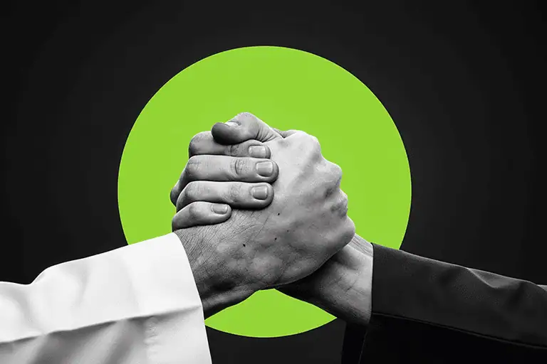 People shaking hands in agreement over a music publishing contract