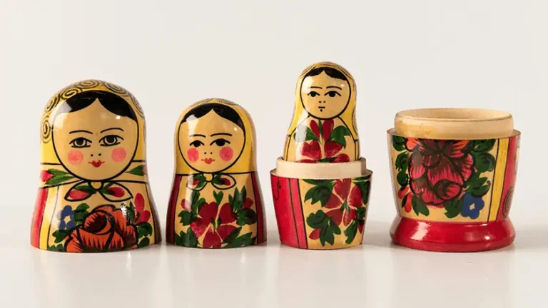 Russian matryoshka nesting dolls partially opened and spread out in sequence, each one revealing another inside, representing the layered corporate ownership structures behind music distribution platforms.