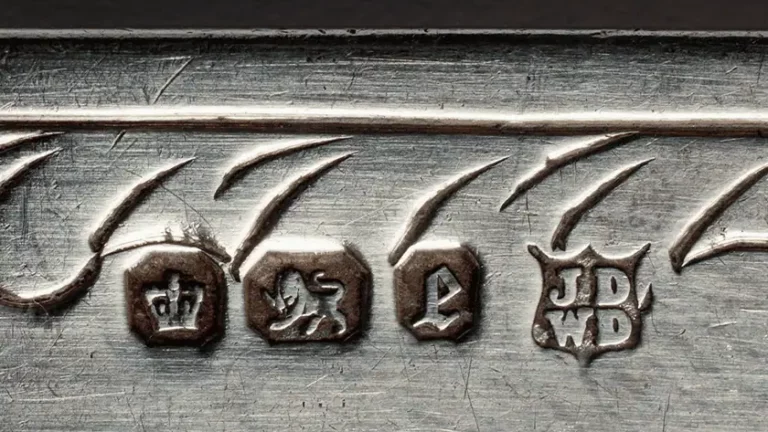 Close up of hallmarks stamped into silver, marks of standard like the recently announced FAC Kitemark for music distributors